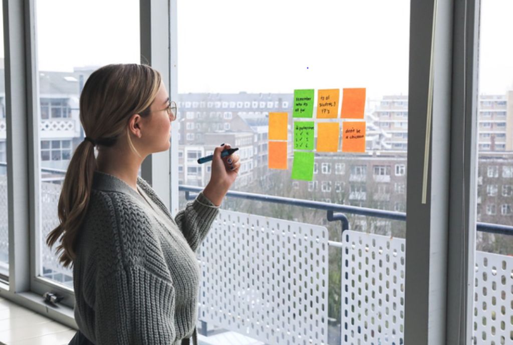 Woman Writing on Sticky Notes