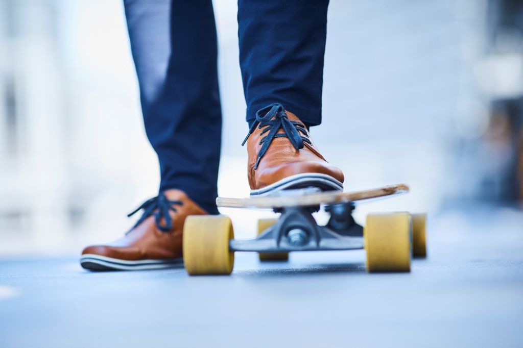 The older man is doing a brisk skating exercise outside to get Fit and Fabulous.